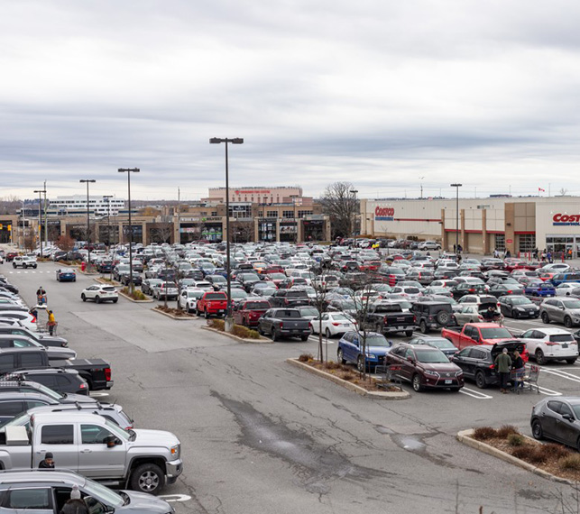 Retail parking lot at a power center full of cars.