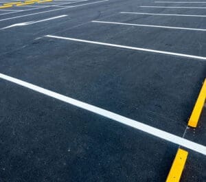 Freshly sealed and striped asphalt parking lot