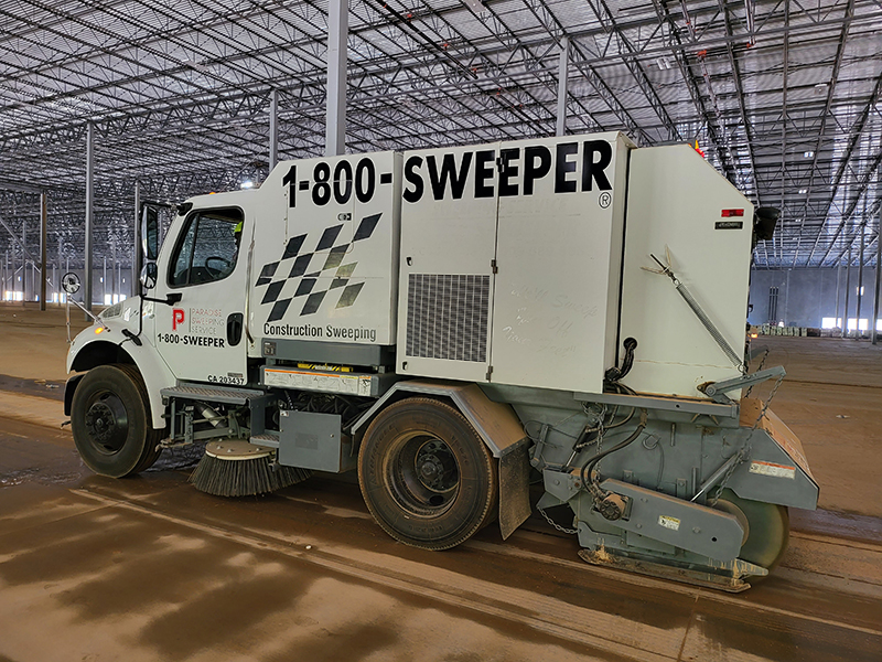 Street sweeper truck sweeping an equestrian facility