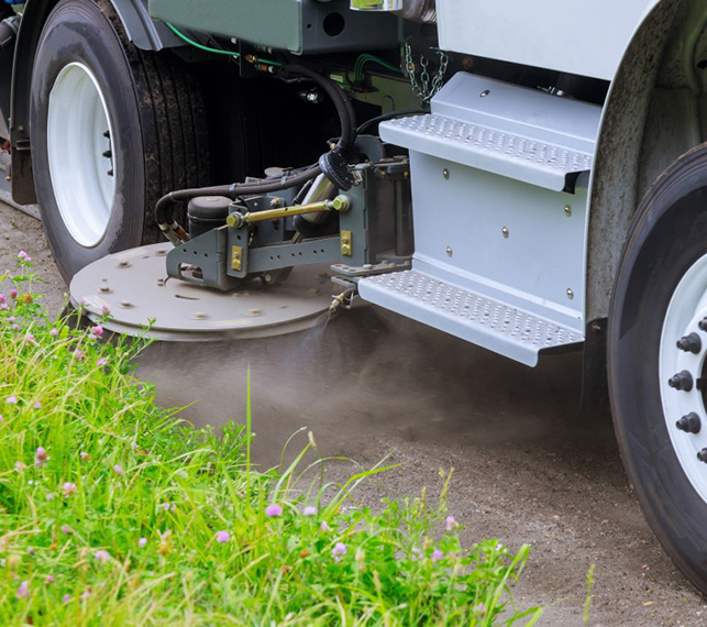 Sweeper truck sweeping a street. street sweeping Charlotte NC