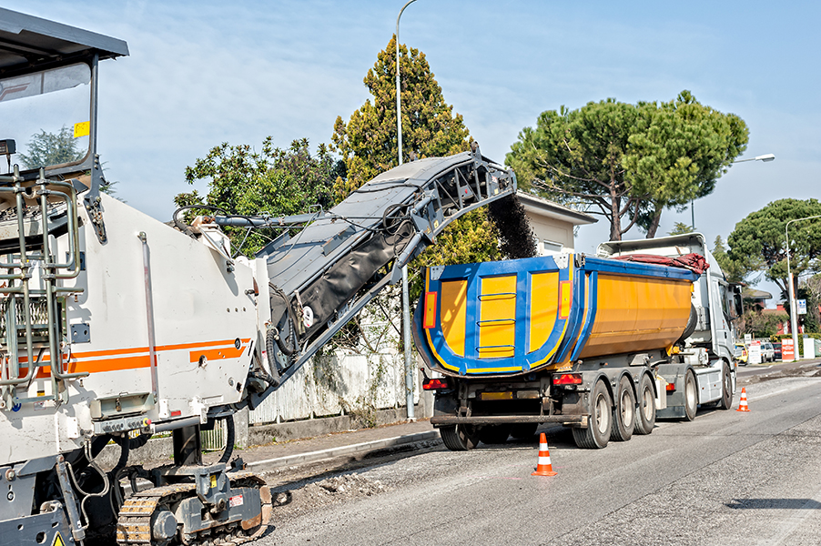 Milling Machine removing old pavement aggregate from a street surface.